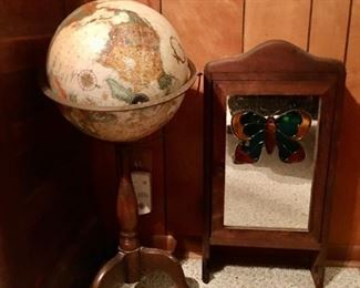 vintage globe on wood base and wall cabinet with glass country detail