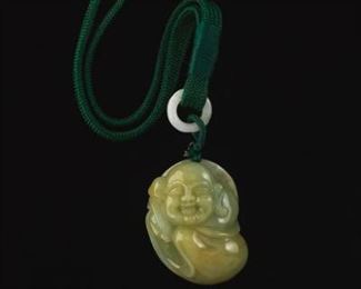 A Carved Jade Buddha on Cord 