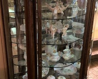 Antique curio cabinet filled with Capodimonte and hand-painted china