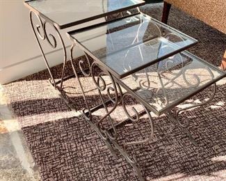 $150; Glass and powder-coated iron nesting tables with safety glass;  (largest table 18"H x 16.5"W x 12.5"D)