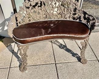 $550 each; Brown powder-coated kidney shaped iron bench with custom removable cushion; #2; 28"H x 38.5"W x 18"D (seat heat 14"H)