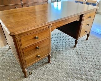 $450; Vintage six drawer, solid walnut desk.  30.5"H x 66"W x 36"D; as is minor sun damage on right side