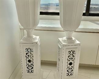 $850; Pair of painted iron urns on stands; each 35"H x 14"D