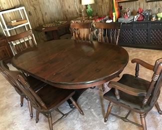solid-wood dining table, shown with two leaves. two armchairs and four side chairs