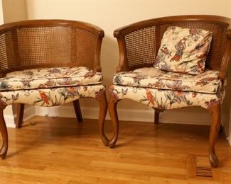 Asian inspired. Cane woven back/arms. Carved wooden arms and legs.30.5" tall x 26.5 wide x 22 x deep. Label on bottom reads "Upholstery by Triumph Orlando, Florida." 