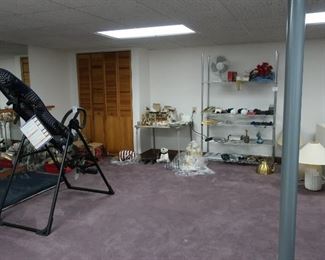 view  of  finished  lower  level with  exercise  equipment, file, lamps, bric  brac