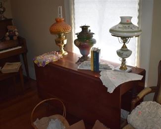 Antique Lamps sit atop this Beautiful Antique Drop Leaf Table