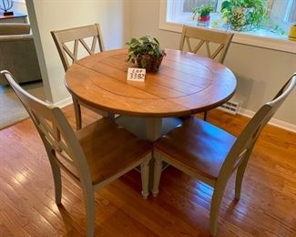 Lot 3382  $425.00. Very Cool Round Dinette Drop Leaf Table with 2 Lower Shelves and 4 Sharp looking Chairs w/ Wood Seats and XX Pattern on Back of Chairs. Greenish Gray 	Table: 41" Diameter 20" W x 41" L as Drop Leaf, Chairs: 17" D x 18" W x 17.5 H, 35.5" H to Back of Chair 	