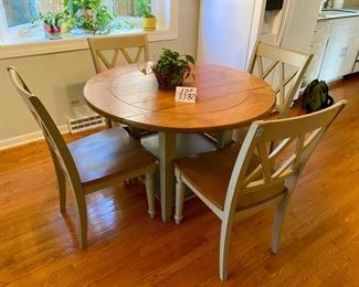 Lot 3382  $425.00. Very Cool Round Dinette Drop Leaf Table with 2 Lower Shelves and 4 Attractive Chairs w/ Wood Seats and XX Pattern on Back of Chairs. Greenish Gray  Table: 41" Diameter 20" W x 41" L as Drop Leaf, Chairs: 17" D x 18" W x 17.5 H, 35.5" H to Back of Chair 	