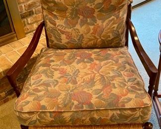 Lot 3391 $145.00. Vintage Arm Chair with Rush Seat and Ladder Back.  Cushions are muted Floral Design.	Back: 38" H Seat 24" D x 30" W x 19" H	