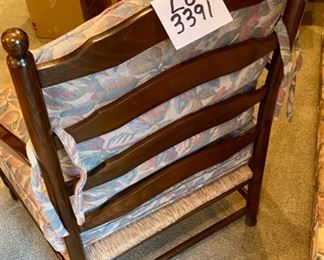 Lot 3391 $145.00. Vintage Arm Chair with Rush Seat and Ladder Back.  Cushions are muted Floral Design.	Back: 38" H Seat 24" D x 30" W x 19" H	