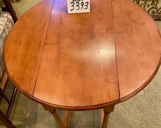 Lot 3393. $125.00. Again, I cannot believe that no one picked up this dropleaf table for half price of $62.50..  It's such a warm honey maple color, very attractive,  When the sides are down, it fits in a nice snug space to hold a lamp, etc., but if you are entertaining and need to bring it out to put appetizers, or what have you, it jumps to the rescue.  Maple Dropleaf Side Table 26" Round, makes a great looking side table.  26" L x 13" W x 24" H	Excellent Condition!