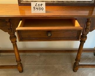 Lot 3400  $275.00  Vintage Drexel Console Table in Dark Oak Finish, 1 middle drawer and 6 Legs. 60" L x 14" D x 25" H	 This is another sweet designer piece - easily can hug a wall as shown, can sit behind a sofa to hold a lamp and some decor, many folks use a sofa table like this so they don't put a sofa right over heat registers.  This is a great combination of form and function, and Drexel (Heritage) makes a very fine table.  Buy it now at half price!!