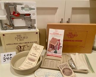 Lot 3406. $60.00   4 pc Mostly Pampered Chef items, new in boxes:  1 Pampered Chef Apple Peeler, Corer, Slicer - looks new in box; 2.  Pampered Chef 8" Mini Baker Stoneware baker, 8" w/ instructions, no box, excellent condition.  3.  Pampered Chef Stoneware Gingerbread House Mold - New in Box - from 1992 not used and 4.  French Bread Warmer - Stoneware disc warms up your bread and keeps it warm.  Nice lot