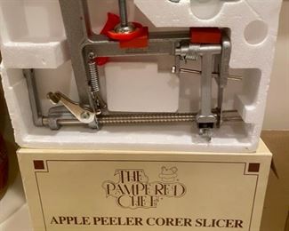 Lot 3406. $60.00   4 pc Mostly Pampered Chef items, new in boxes:  1 Pampered Chef Apple Peeler, Corer, Slicer - looks new in box; 2.  Pampered Chef 8" Mini Baker Stoneware baker, 8" w/ instructions, no box, excellent condition.  3.  Pampered Chef Stoneware Gingerbread House Mold - New in Box - from 1992 not used and 4.  French Bread Warmer - Stoneware disc warms up your bread and keeps it warm.  Nice lot