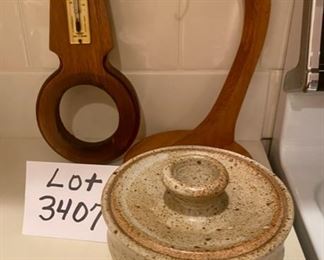 Lot 3407  $20.00. Random Lot, 1) 4"x5,5" stoneware crock exc. condition and no branding, 2.)A thermometer on Wood 12" tall, made in England Shows Fahrenheit and Centrigrade.  3.) Banana Holder, 12" tall.  I keep meaning to pick one up and forget about it.    