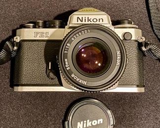 Lot 3405  $125.00. Nikon FE-2 SLR Film Camera in Excellent Condition, Includes Nikkor 50mm 1.1.8 Lens and Nikon CF-2 Case.