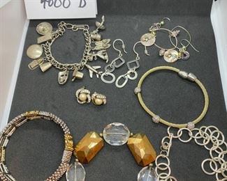 Jewelry Lot 4000-D. $45.00. 8 pieces of nice Costume Jewelry:  1. Vintage Charm Bracelet w/12 Silver Plate Charms.  2.  Stretchy silver and gold-tone bracelet, 3.  Gold and Clear Lucite Type Bead Bracelet, 4.  Chain bracelet and 5. Matching earrings, 6. Pierced Hoop earrings, 7. Pearl & Rhinestone Earrings, 8.  One gold and silver bracelet.  Orig. Lot 1334