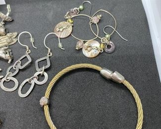 jewelry Lot 4000-D. $45.00. 8 pieces of nice Costume Jewelry:  1. Vintage Charm Bracelet w/12 Silver Plate Charms.  2.  Stretchy silver and gold-tone bracelet, 3.  Gold and Clear Lucite Type Bead Bracelet, 4.  Chain bracelet and 5. Matching earrings, 6. Pierced Hoop earrings, 7. Pearl & Rhinestone Earrings, 8.  One gold and silver bracelet.  Orig. Lot 1334