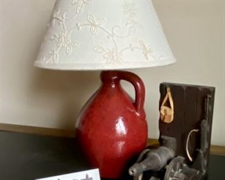 Lot 3463.  $25.00  Cool Wood Cannon bookend and jug-style desk lamp, of pottery.