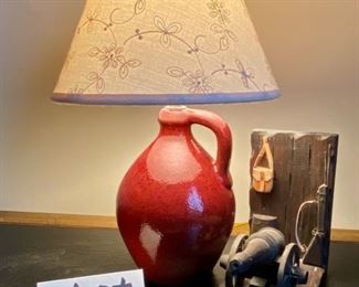 Lot 3463.  $25.00  Cool Wood Cannon bookend and jug-style desk lamp, made of pottery.