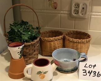 Lot 3436 $20.00.  Basket with faux greenery, double basket, a candle with grapes in terracotta pot, watering can planter, mountain mug/saucer, small pot		