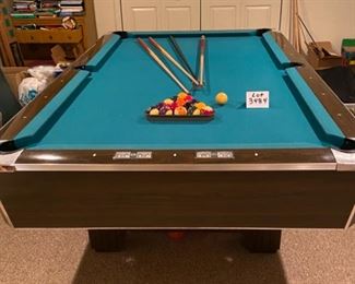 Lot 3484. $750.00.. 8' Regulation Pool Table, Includes Pool Cues, Racks, Brush, Cue Storage Rack & Set of Billiard Balls.  1950's style pool hall table w/nostalgic look. Will need to be professionally moved. Bumper cushions. 96" L x 57" W