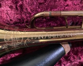 Lot 3494   $95.00. Pan American Trumpet, Vintage Made in Elkhart, IN, plus case, music stand, and mute. Serial No. 162971. This trumpet could probably use an inspection by a trumpet guy or gal - the keys move up & down smoothly but there is some surface wear starting .  Good project to rehabilitate this beauty during the time of Covid.  