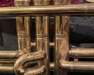 Lot 3494   $95.00. Pan American Trumpet, Vintage Made in Elkhart, IN, plus case, music stand, and mute. Serial No. 162971. This trumpet could probably use an inspection by a trumpet guy or gal - the keys move up & down smoothly but there is some surface wear starting, as you can see from this photo .  Good project to rehabilitate this beauty during the time of Covid.  