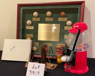 Lot 3519   $95.00 Golf Lot includes: Sylvania Country Club "50 Years of Progress Plaque, Box Signed by Arnold Palmer, "The Evolution  of Golf Balls" in Shadow Box (The Golf Ball Replicas include: Feathered, Hand Hammered, Machine Guttie, The Dunlop, Par Player, Nimble, Mesh Pattern, Golden Arrow and Air Flight;  Brass Golf Club Bookends and Hole-in-One Gumball Machine  