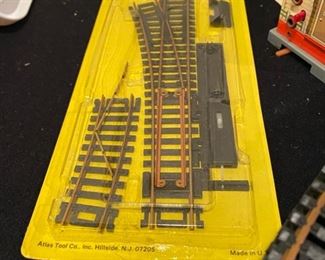 Lot 3542. $125.00 Complete HO Train Set including Locomotives, Train Cars, Track, 2 Tyco Hobby Transformers and Table Top Train Board (Layout) 67.5" L x 46" W