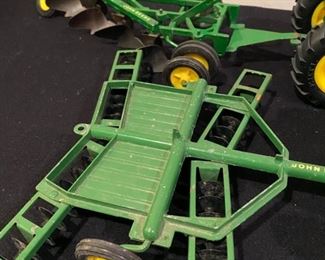 Lot 3487. $95.00  6 Pc. Vintage John Deere Tractors & Wagons H6862, Plow and Disco Cultivator.  Wheels & Tires good shape. Paint on the newer tractor is excellent