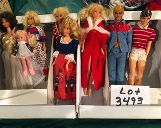 Lot 3493-B:   $40.00. Dolls: 2 Skippers, 3 Barbies, 2 Kens, 1 baby and a Barbie  Fashion Doll Trunk (1975)