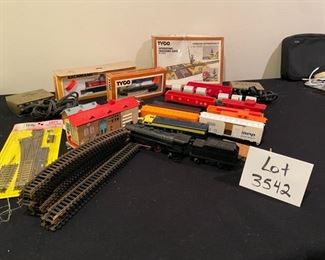 Lot 3542. $125.00 Complete HO Train Set including Locomotives, Train Cars, Track, 2 Tyco Hobby Transformers and Table Top Train Board (Layout) 67.5" L x 46" W