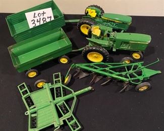 Lot 3487. 6 Pc. Vintage John Deere Tractors & Wagons H6862, Plow and Disco Cultivator.  Wheels & Tires good shape. Paint on the newer tractor is excellent