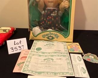 Lot 3537 $35.00. Cabbage Patch Kids Doll In Original Box, Still Secured to box, Doll is in amazing condition, the box is as shown.  Adoption and Birth Cert and all info included! Adi Lois