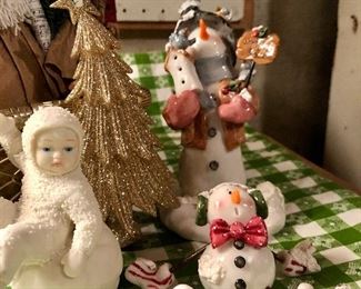 Lot 3539. $40. Big Lot of Christmas items:  2 Father Christmas Figures, Birch Hearts Friendship Snowman, Santa w/tree and votive holder, 2 Nancye Williams snowman figures, Snow Baby Bisque, Snowman for hire (Obviously), Gold Metal Star Basket and Rolly Santa! Gold Wreath with Santa.