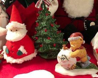 Lot 3541.  $60.00 Merry Christmas Tree Skirt (46"dia), Faux Pointsettia (20"h), Santa bag with Christmas Tea Towels, 2 plush felted santas (real cute), 1 quilted santa (Overly-Raker), 1 straw hat snowman with cute buttons, 1 santa pillow, ceramic tree (good shape, one missing berry and small chip), Cute snow house, 1 Wonderful World of Rambling Ted Figurine (OOOOPs) 1999. 
