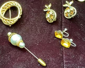 Jewelry Lot 4000-R.  $42.00.  Eight pieces of vintage costume jewelry - 4 pairs of clip or screw-on earrings, one gold-tone ribbon brooch with a topaz stone (Yay Scorpio's!) in the center, one other gold-tone pin, one stick-pin with interesting head on - crafted of pearl and gold tones, and last a neat ponytail holder, attached to a stretchie...for a more elegant ponytail.  