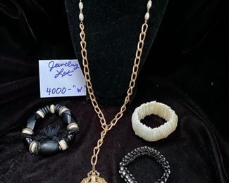 Jewelry Lot 4000-W.  $25.00. Three Costume Jewelry Stretchy Bracelets, one mother of pearl, one black with rhinestones, and one black alternating with cream, all individually interesting, and a gold-tone and pearl long chain necklace, with a large oval pendant featuring cherubs. Not as tacky as it sounds, lol.  It's a sweet lot!
