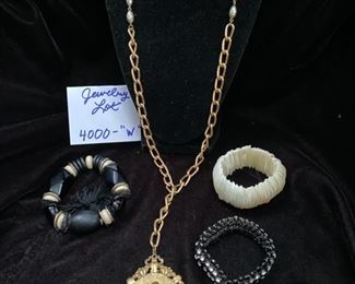 Jewelry Lot 4000-W.  $25.00. Three Costume Jewelry Stretchy Bracelets, one mother of pearl, one black with rhinestones, and one black alternating with cream, all individually interesting, and a gold-tone and pearl long chain necklace, with a large oval pendant featuring cherubs. Not as tacky as it sounds, lol.  It's a sweet lot!