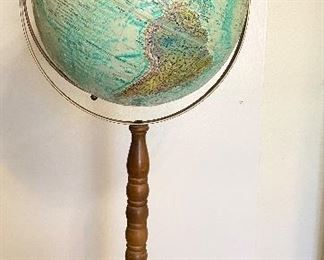 Vintage "Replogle" World Ocean Series globe on stand. 12" diameter raised relief globe. Metal base and walnut wooden spindle stand. Measures 32" tall. See additional photos for close up. One spot shows wear area. $80