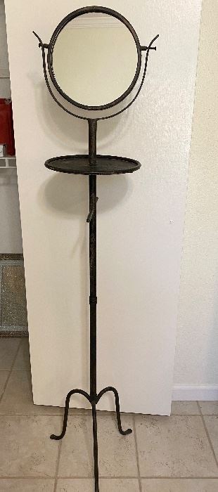 Old metal shaving stand with mirror and towel bar. Not the original mirror. Measures 61" tall. Does unscrew into 2 pieces. Thought to be from an old hotel or rooming house. $90