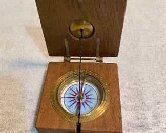 Wooden case and brass compass. $35