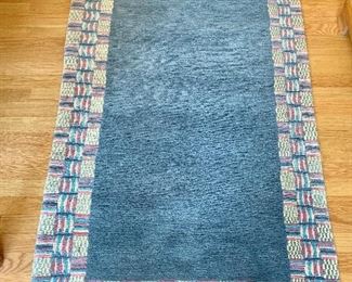 $150 - Tibetan rug with decorative border 5 ft. 8 in. (including fringe) x 3 ft.