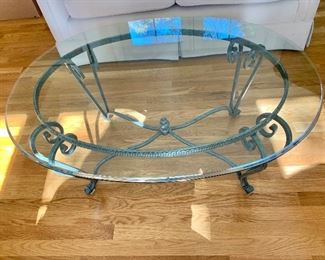 $250 - Oval glass top table on metallic base; 18 in. (H) x 40 in. (L); x 30 in. (W)