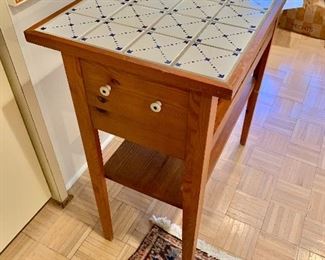 $125 - Tile topped work table with two shelves; 34” W x 18” D x 36” H