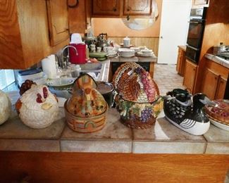 Chickens, Fish, and Duck Kitchen Tureens ALSO Nice Black fridge is for sale (far right of photo)