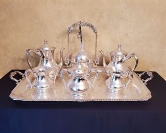 Silver service...tray is 28" wide and 18" deep. The teapots are 9" tall with the largest teapot measuring 12" tall.