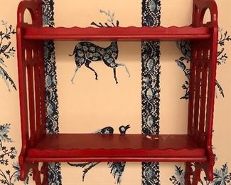 Red painted wall shelf